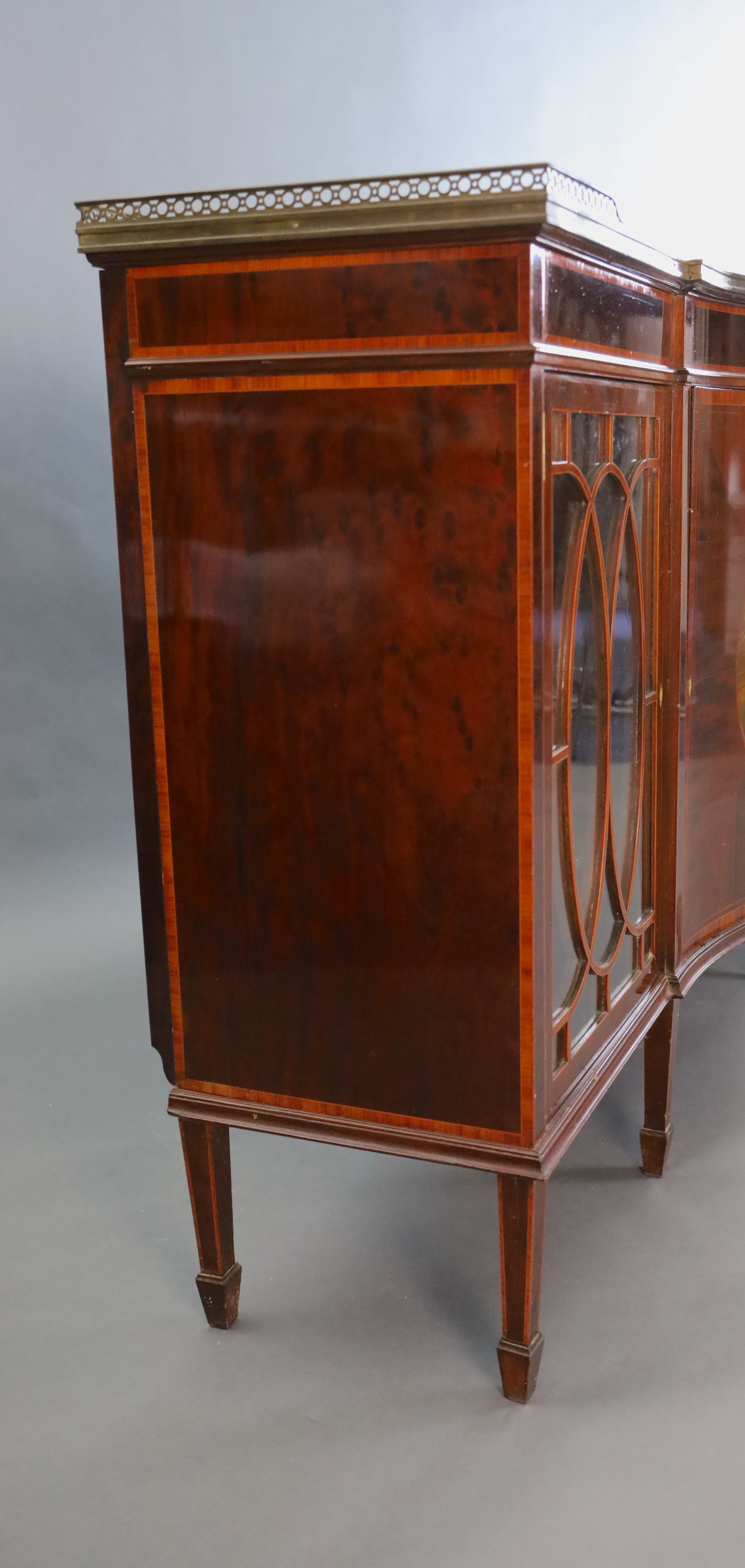 An Edwardian rosewood banded mahogany serpentine dwarf bookcase, W.5ft 1.5in. D.1ft 6in. H.3ft 3in.
